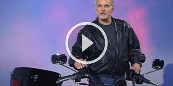 Man standing behind motorcycle