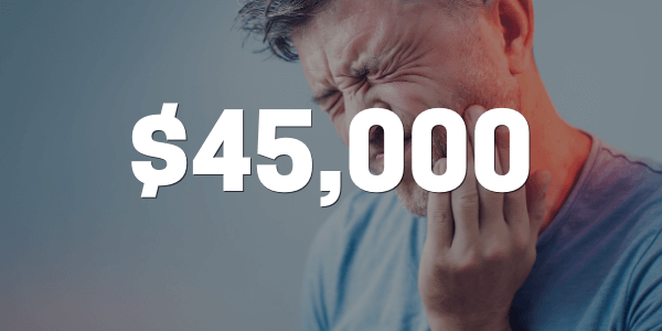 A person in pain holding their mouth after they bit on a bone in pizza that was awarded $45,000