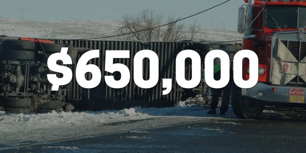 Truck accident scene with truck rolled over on snowy road
